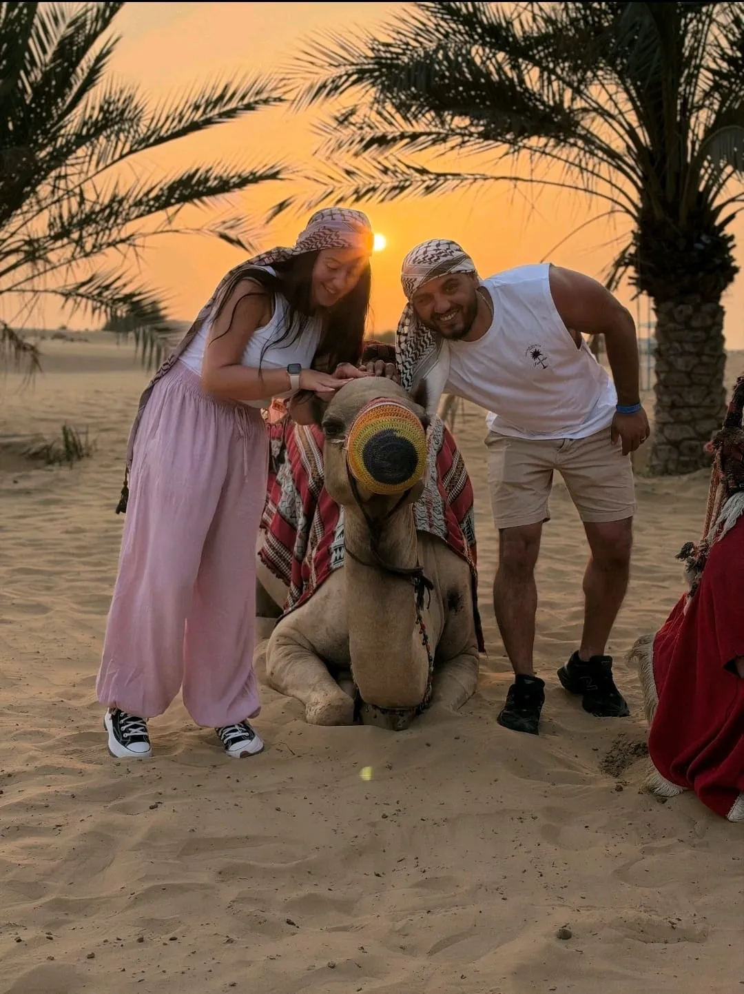camel ride across a golden desert landscape during a Camel Safari Dubai adventure